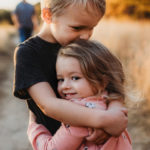 two children hugging outside