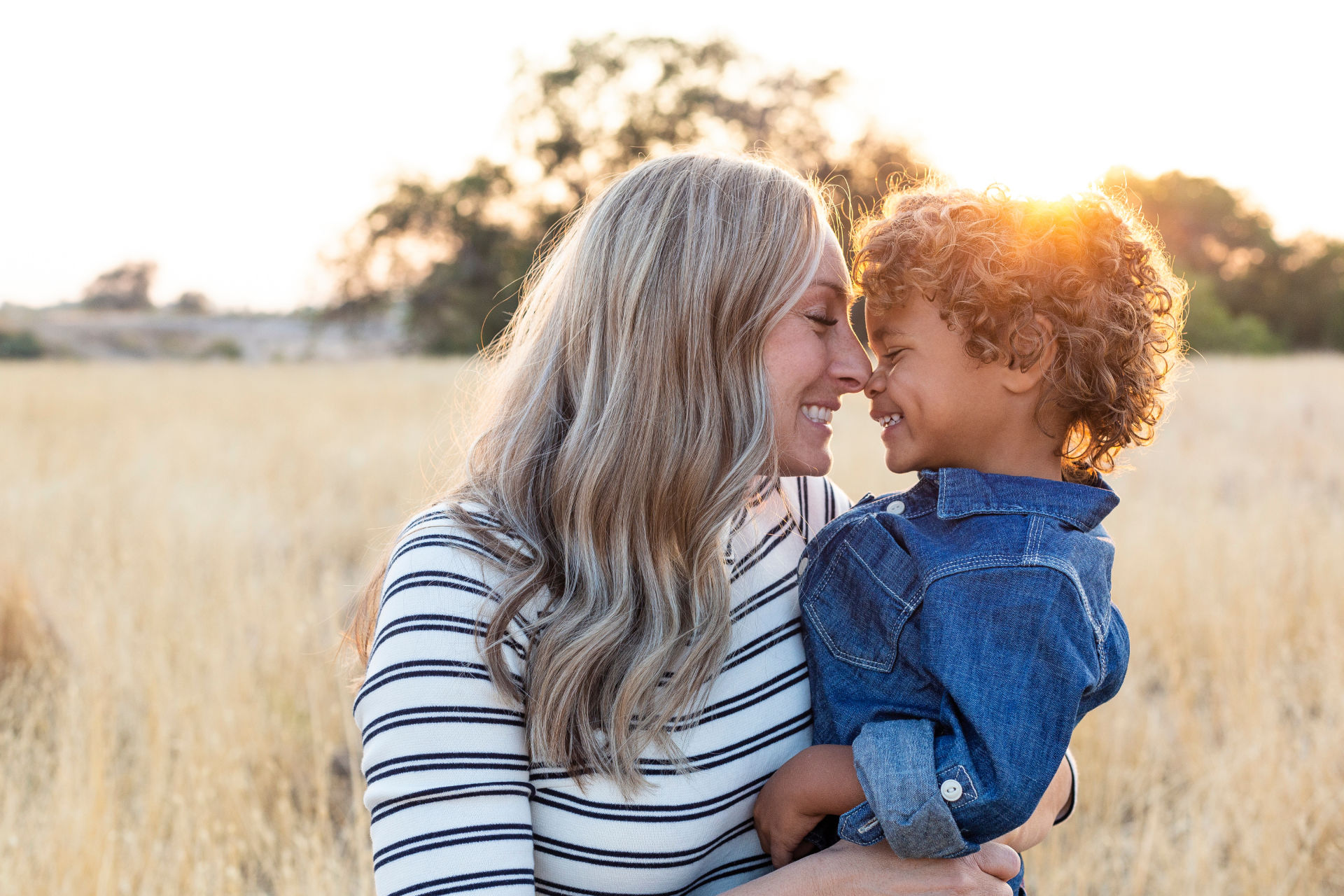 mother holding a child in a field